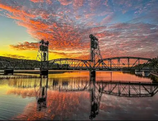 Cape Cod Canal Railroad Bridge at sunset with colorful skies reflecting across the calm canal waters.