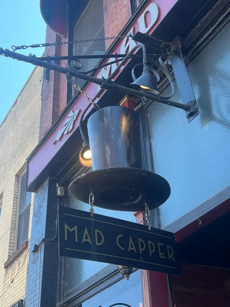 Mad Capper building showing its distinct top-hat storefront sign.